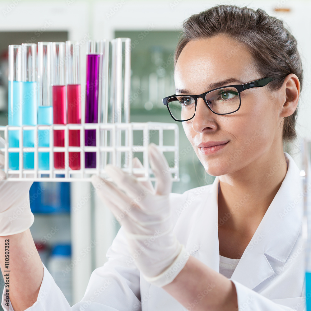 Woman analyzing test tube with liquid Woman analyzing test tube with liquid