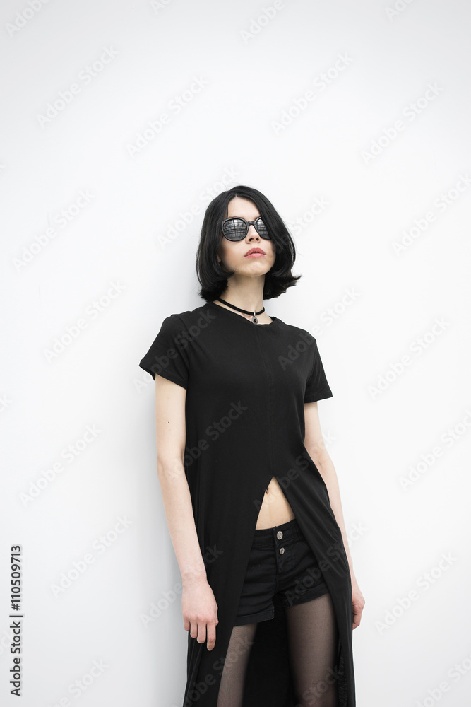 Portrait of posing model with black hair against of white wall Portrait of posing model with black hair against of white wall