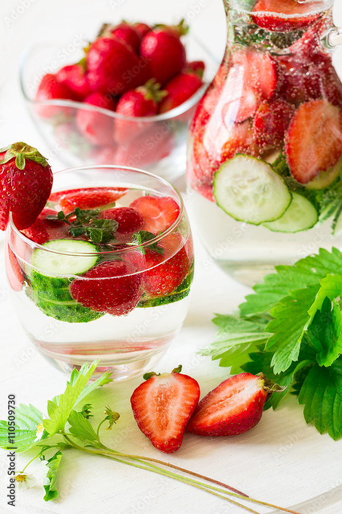 Detox. Fresh lemonade with strawberries, cucumber and mint on white wooden table