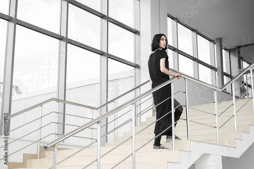 Woman in black walking upstairs