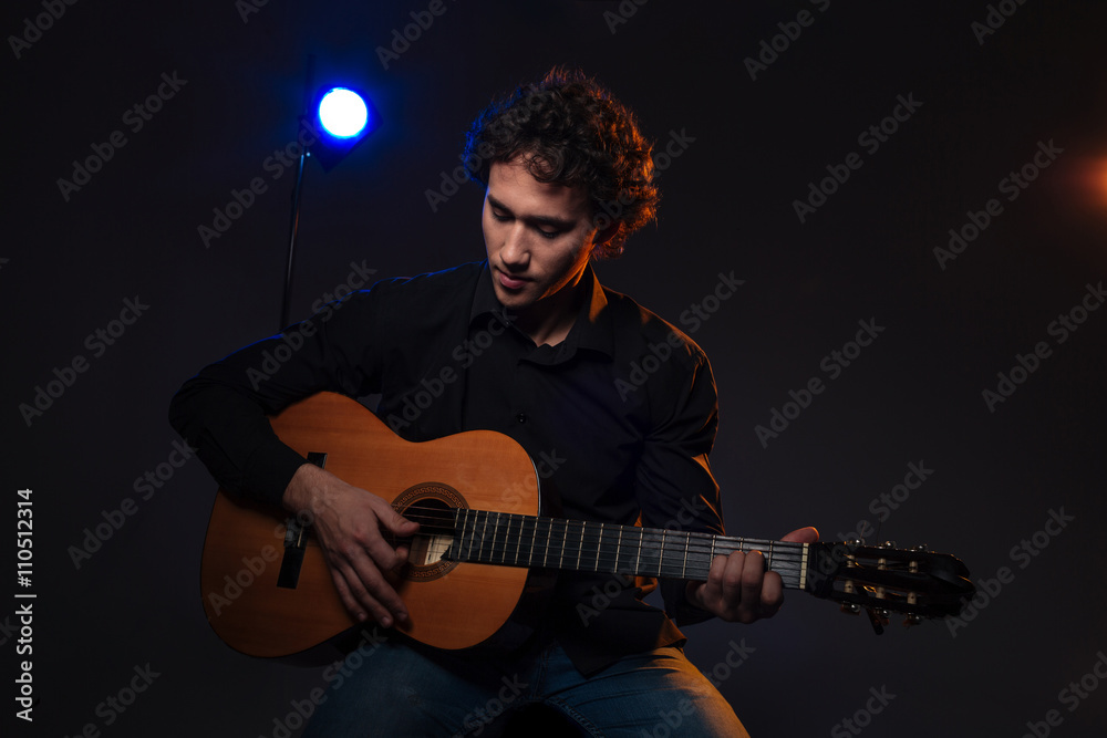 Obraz premium Young man playing on guitar
