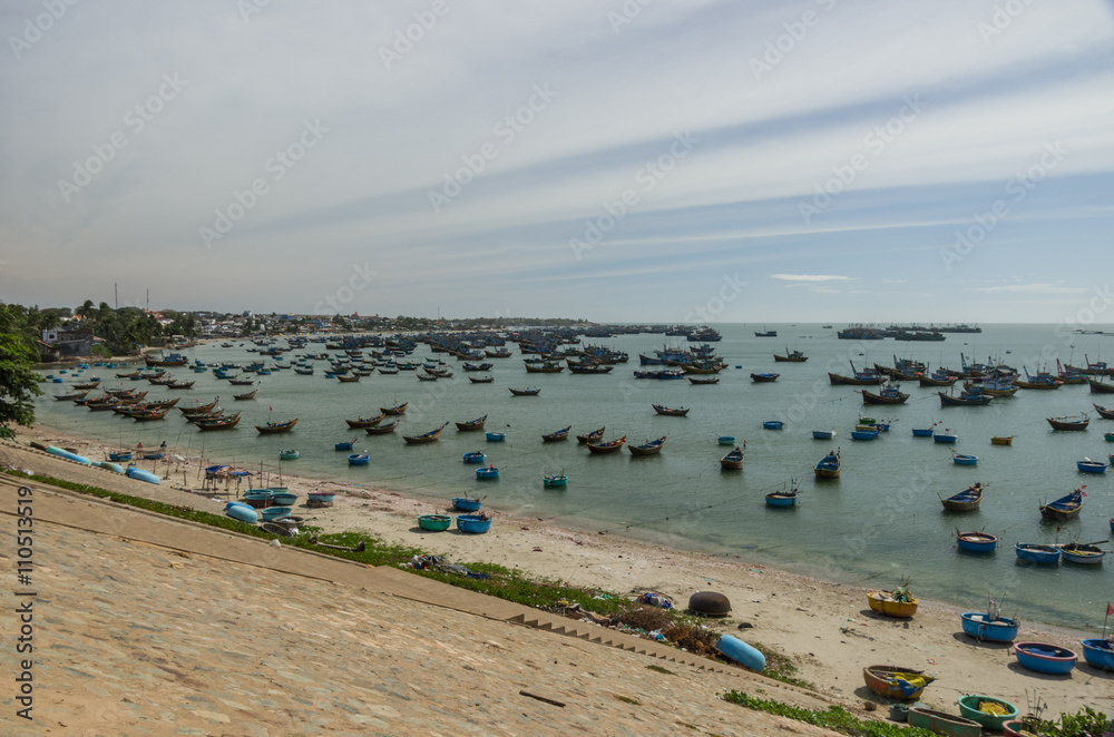 Fishing village and colorful fishing boats near Mui Ne at a sunny day. Vietnam