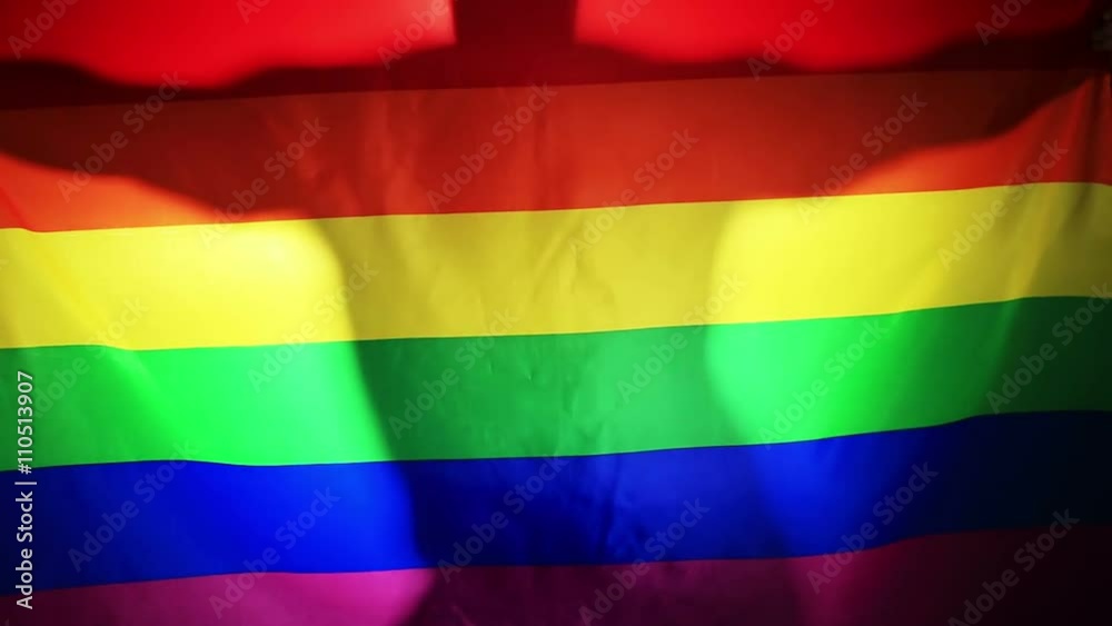 dancing silhouette of a man against a background of the flag of the LGBT community dancing silhouette of a man against a background of the flag of the LGBT community
