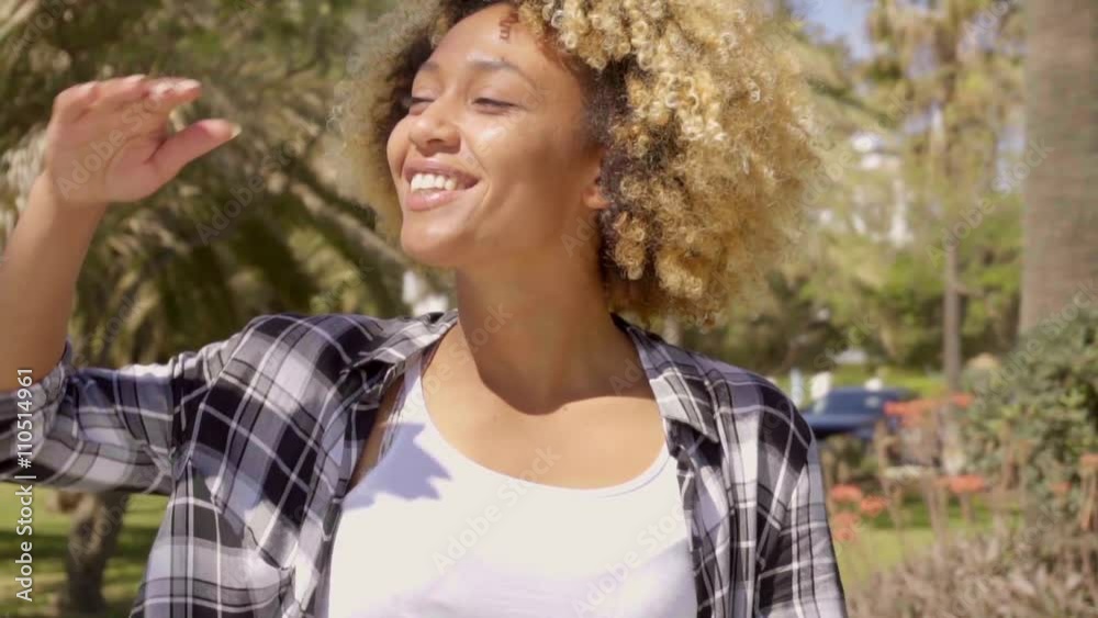 Young woman looks into the distance. She holding her hand to her forehead protecting her eyes from the sun and looking around. Young woman looks into the distance. She holding her hand to her forehead protecting her eyes from the sun and looking around.