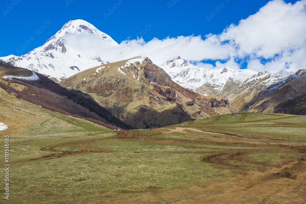 Kazbek peak mountains and blue sky. Georgia.