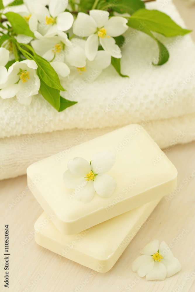 SPA setting. Jasmin soap and flowers and on wooden table SPA setting. Jasmin soap and flowers and on wooden table