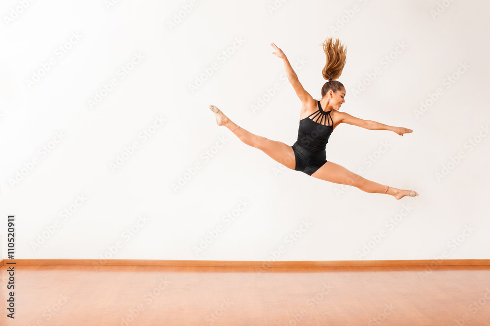 Happy female dancer up in the air