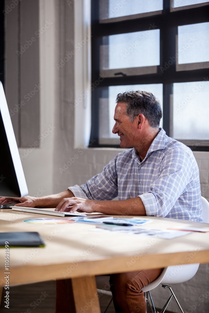Smiling man working on computer Smiling man working on computer