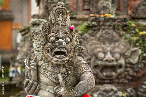 Traditional demon guard statue stone carved in Ubud, Bali island.
