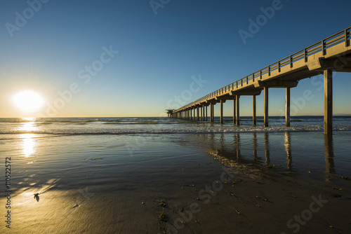Wide angle shot of Scripps Pier with reflection during sunset with sun in La Jolla, San Diego, California © Andriy Blokhin