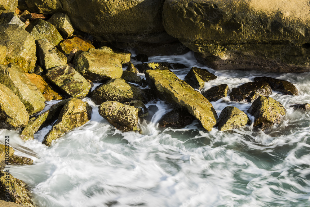 Fototapeta premium Soft, crashing waves in the rocky coves of the Sunset Cliffs in San Diego, California
