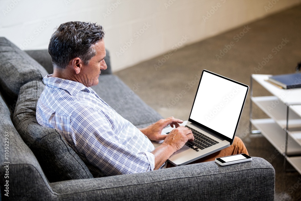 Profile view of a businessman working on computer Profile view of a businessman working on computer