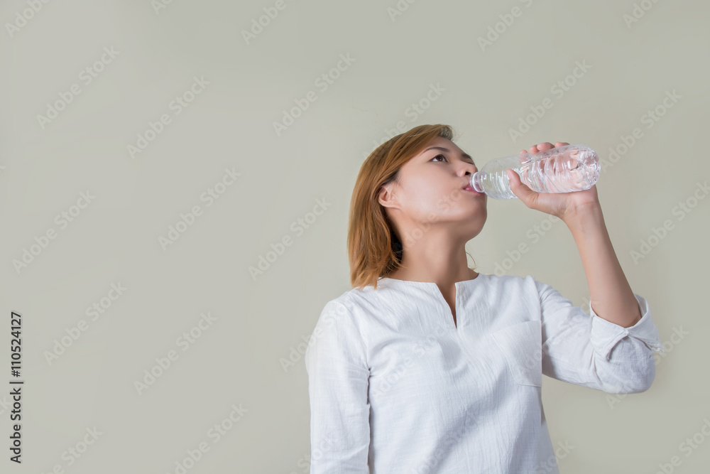 Young healthy woman holding bottle of water and smiles at camera Young healthy woman holding bottle of water and smiles at camera