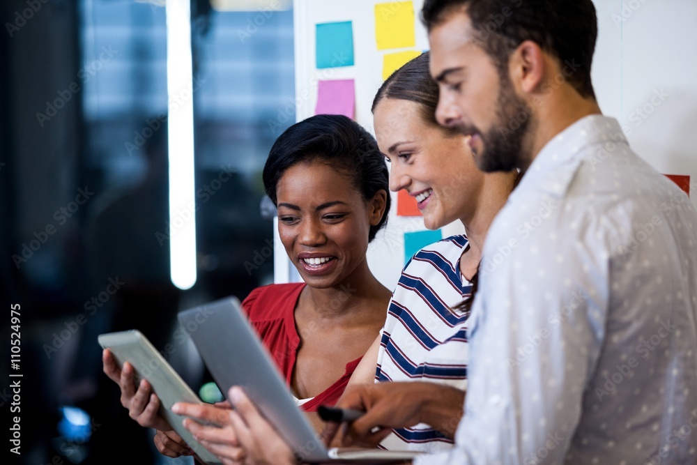 A young business team discussing together A young business team discussing together