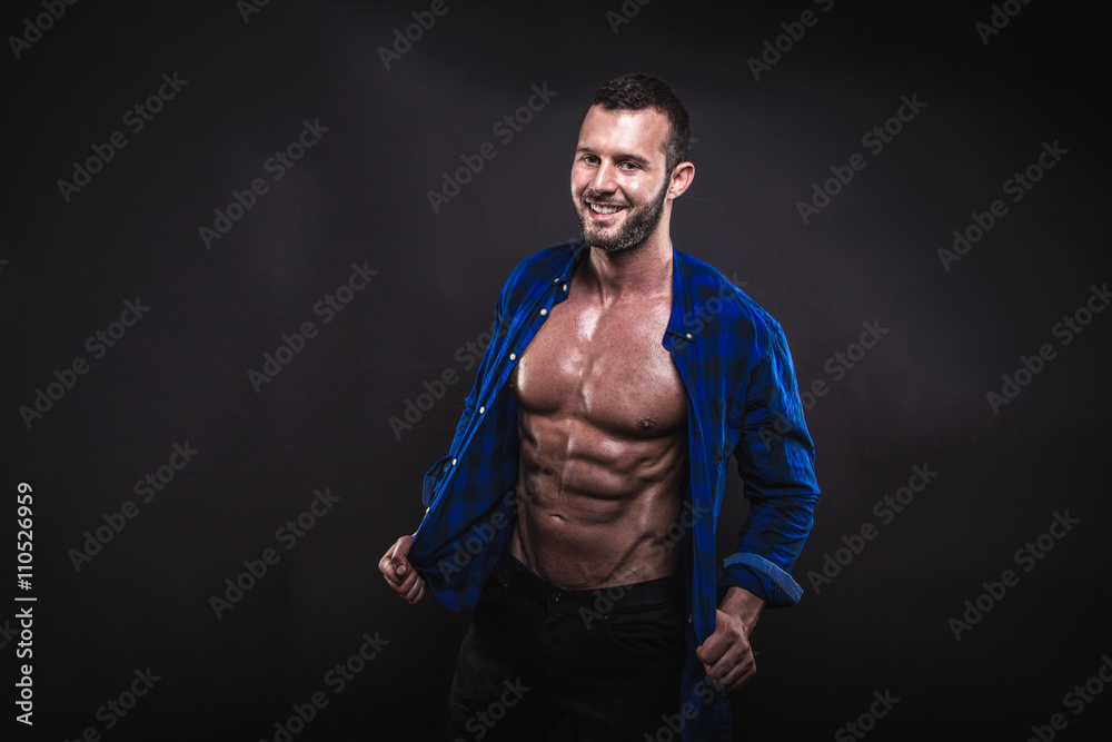 Muscular male model posing in studio.