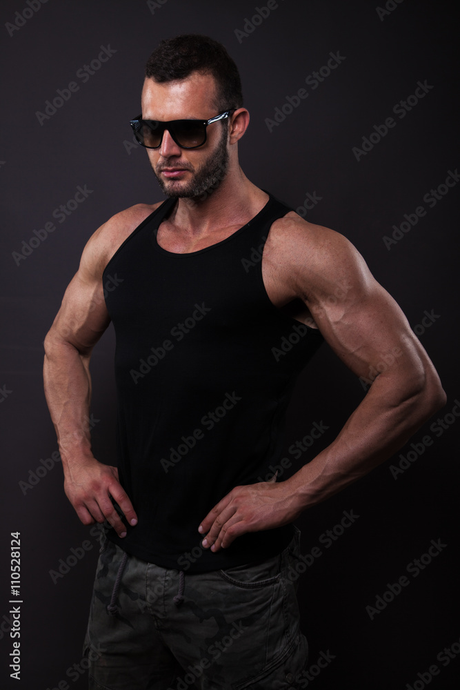 Muscular and fit man posing in studio. Muscular and fit man posing in studio.