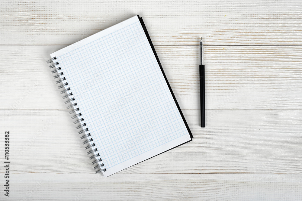 Top view of open empty notebook and black pen. Top view of open empty notebook and black pen.