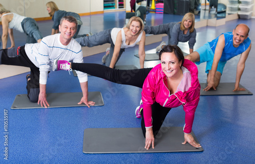 people training in a gym on sport mats