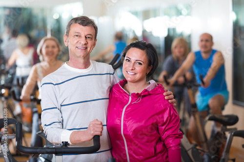  man and woman posing in a gym and smiling