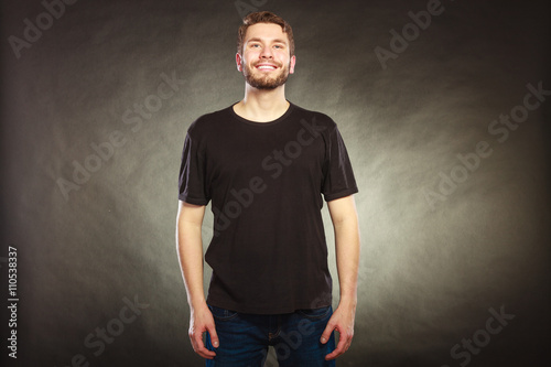 Happy man in blank shirt with empty copy space.