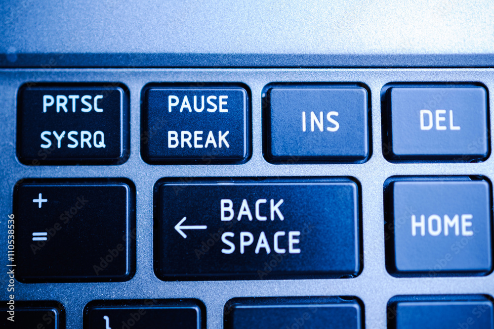 Backspace button on the keyboard closeup surrounded with Print Screen, Pause  Break, Insert , Home and other buttons in blue color cast Stock Photo |  Adobe Stock