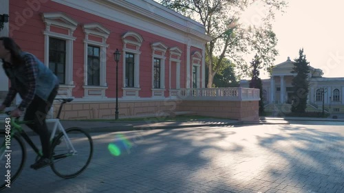 Young hipster man riding gixed gear bike in old city center photo