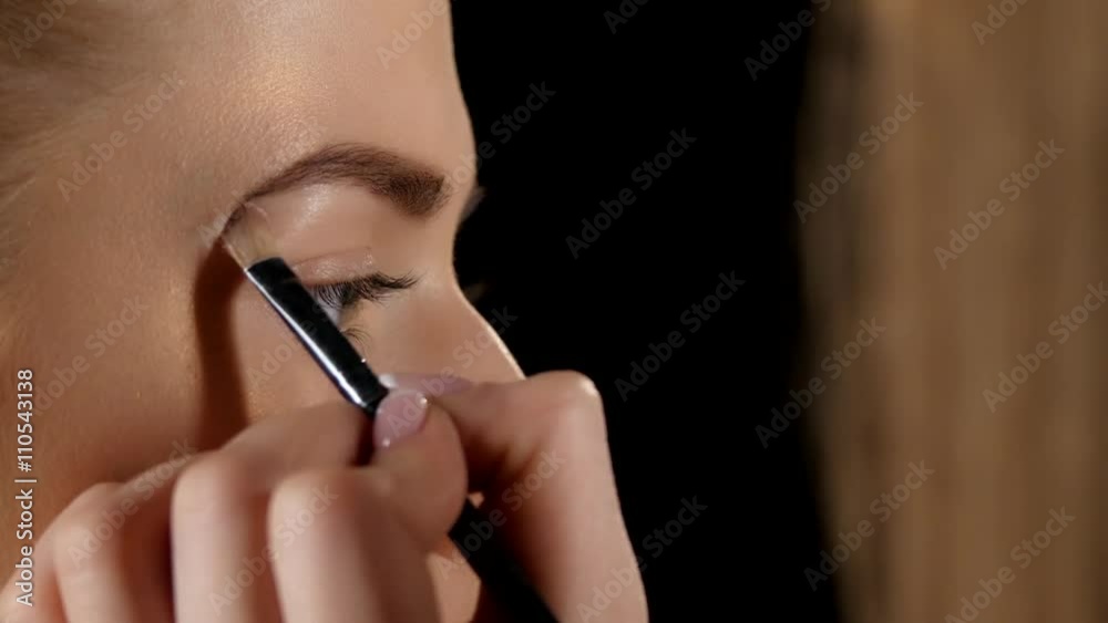 Applying eyebrow brush. Makeup. Black. Closeup Applying eyebrow brush. Makeup. Black. Closeup
