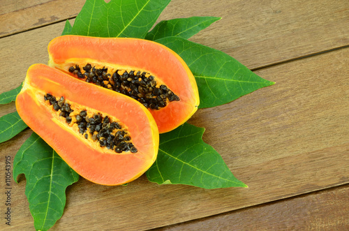 Ripe papaya on wood background.