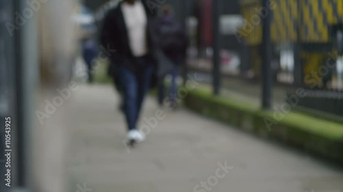 Wallpaper Mural  Serious man walking alone, away from railway station. Torontodigital.ca