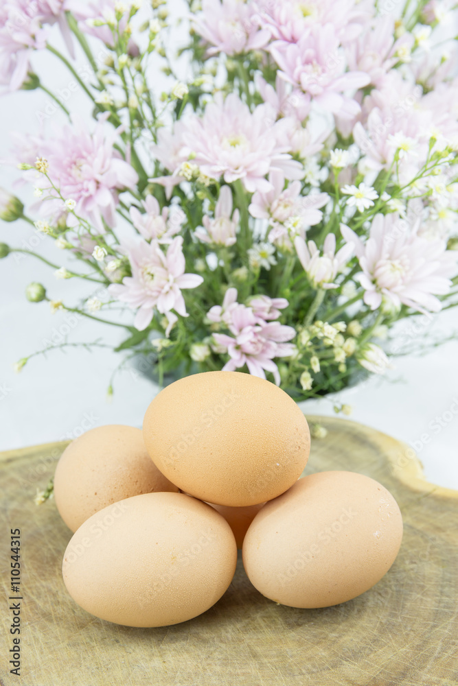Eggs on chopping block on vintage wooden background