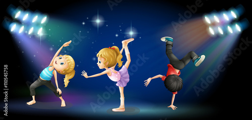 Three kids dancing on the stage © GraphicsRF