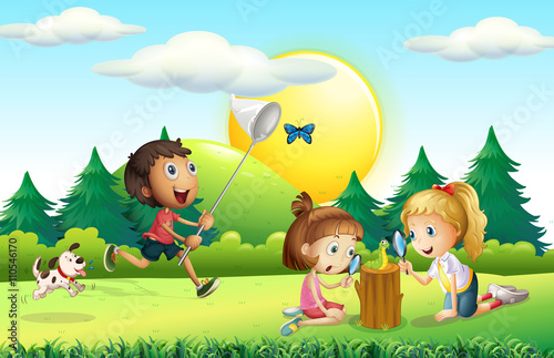 Children catching butterfly in the garden