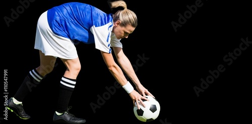 Portrait of sportswoman playing football 