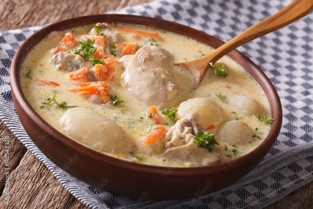 Belgian cuisine: cream soup with chicken close up in a bowl. horizontal
Belgian cuisine: cream soup with chicken close up in a bowl. horizontal