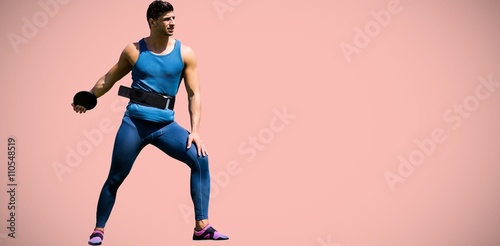 Composite image of portrait of sportsman practising discus throw