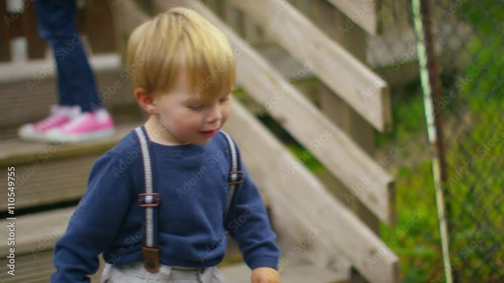 Happy little boy with lots of energy playing on his own outdoors Happy little boy with lots of energy playing on his own outdoors
