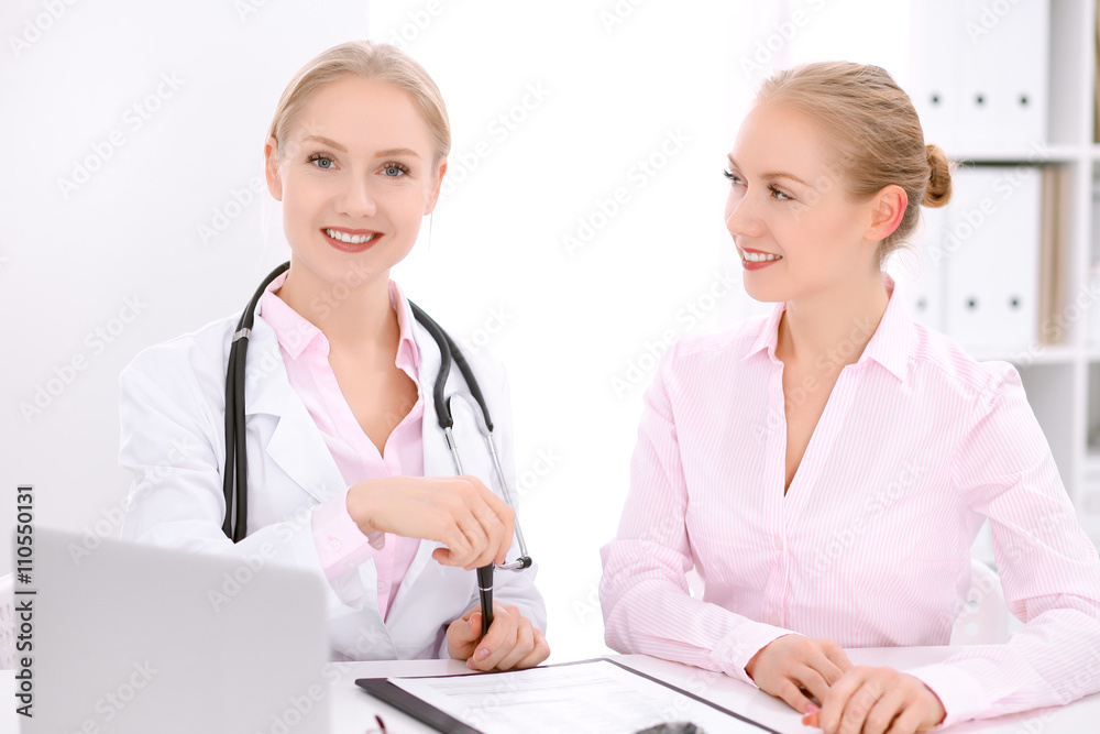 Doctor and patient sitting at the desk Doctor and patient sitting at the desk