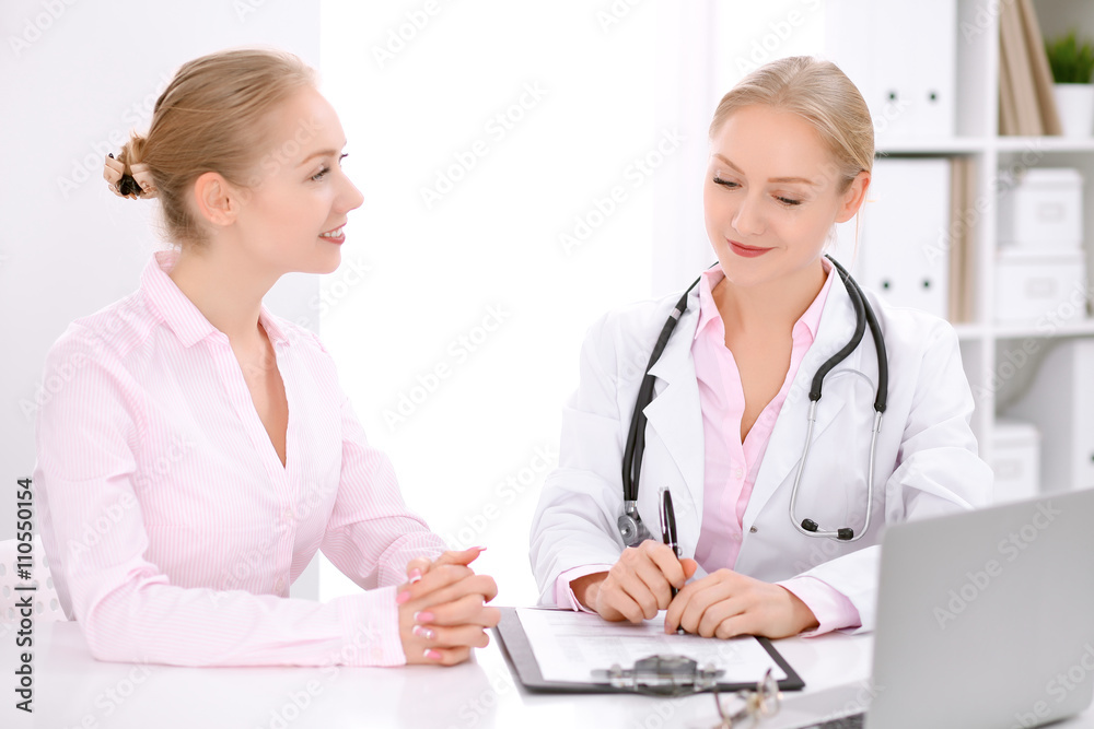Doctor and patient sitting at the desk Doctor and patient sitting at the desk