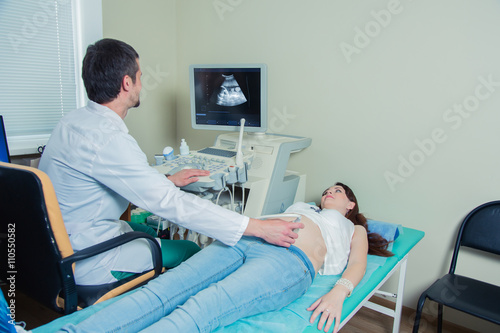  pregnant woman laying on the couch during ultrasound checking 