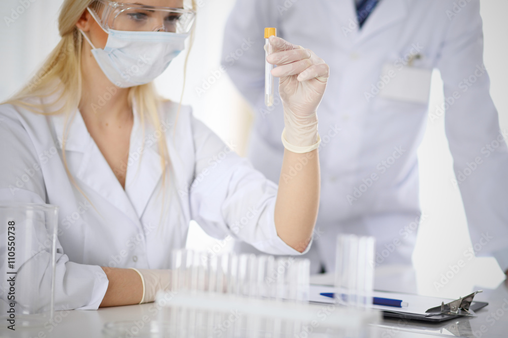 Scientific research team with clear solution in laboratory Scientific research team with clear solution in laboratory