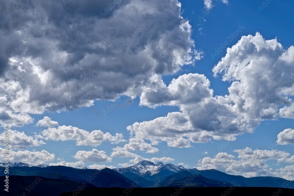 Sky, Clouds, Snow Capped Mountains, Silhouettes of Hills and Trees. North Cascades National Park, Winthrop, WA, USA Sky, Clouds, Snow Capped Mountains, Silhouettes of Hills and Trees. North Cascades National Park, Winthrop, WA, USA