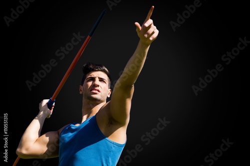 Low angle view of sportsman practising javelin throw 