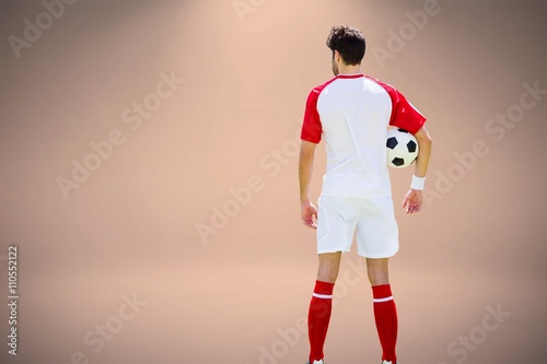 Fototapeta Naklejka Na Ścianę i Meble -  Composite image of rear view of man wearing soccer uniform and h