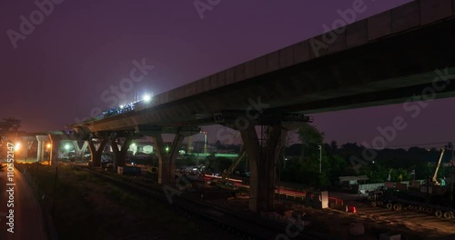 Timelapse night to dayt at express way construction site over rail road in Bangkok, Thailand photo