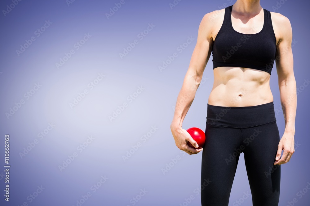 Composite image of sporty woman holding a red ball Composite image of sporty woman holding a red ball