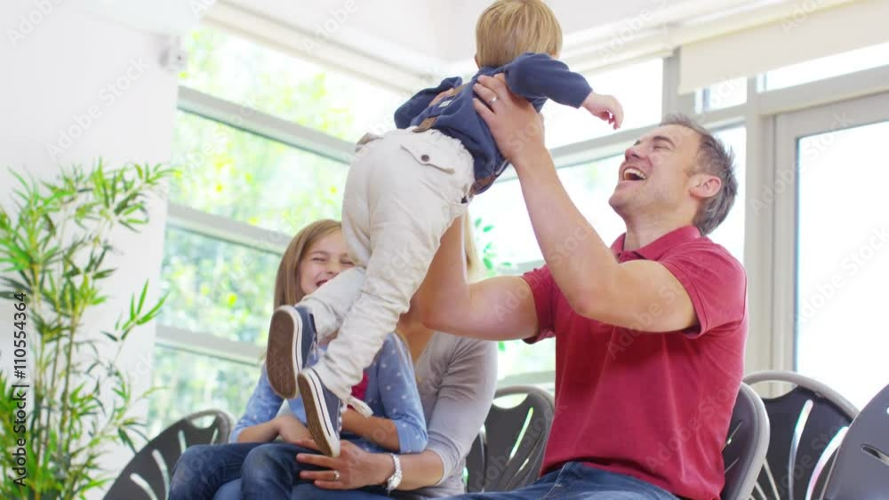 Cute little boy runs to his father in medical waiting room. Cute little boy runs to his father in medical waiting room.