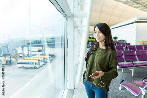 Woman listen to music at airport