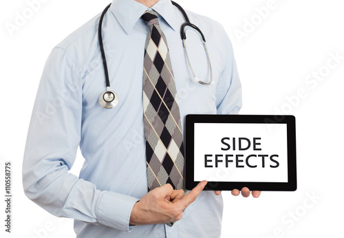 Doctor holding tablet - Side effects photo