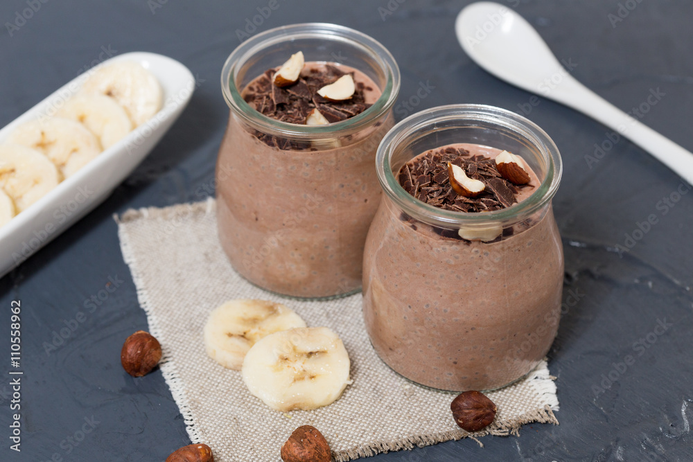 Fototapeta premium Chocolate pudding with chia seed, bananas and nuts, in a glass