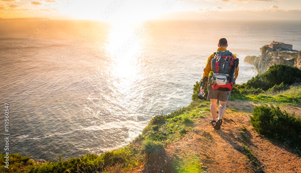 Fototapeta premium Young Explorer Walking Towards Sunset
